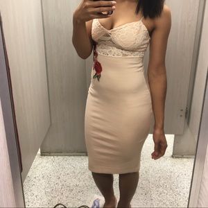 Nude semi long dress with a rose embodiment